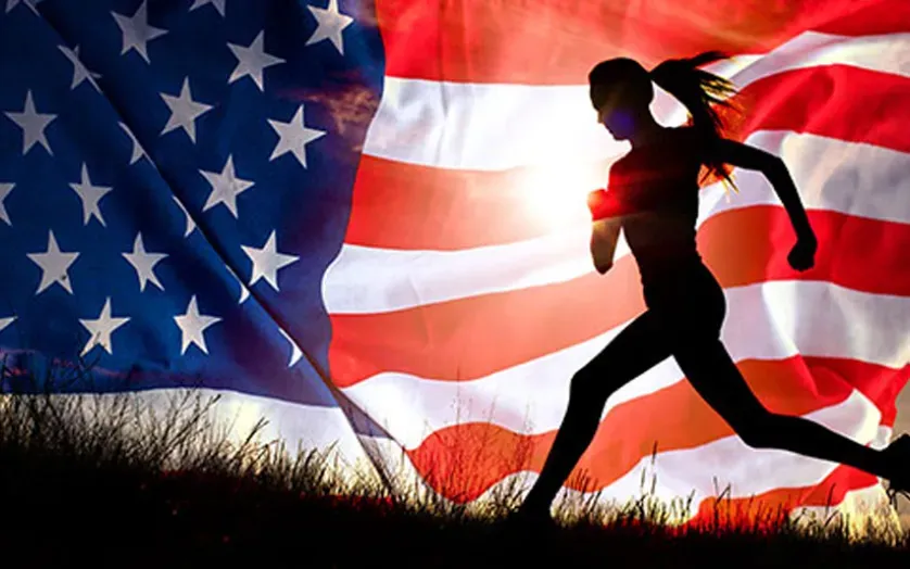 A picture of an American Flag and a female runner in a black sillouette.