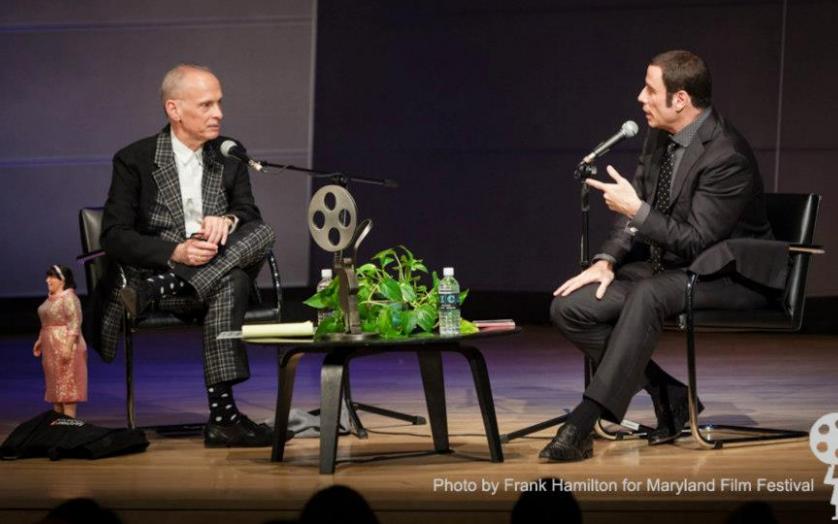 John Travolta on stage interviewing  John Waters