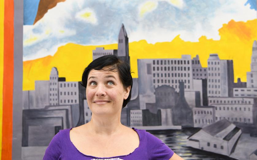 woman in front of mural