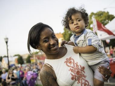 Mom holding child at Festival