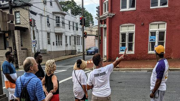 Dee Jenkins pointing to 100 W. All Saints Street in Frederick.