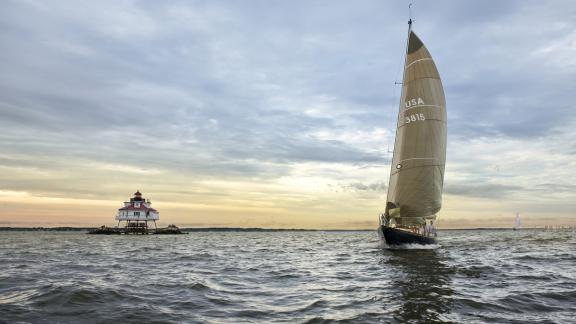 Sailboat racing past Thomas Point Lighthouse