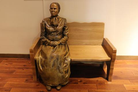 Bronze statue of Harriet Tubman sitting on a bench at the Harriet Tubman Visitors Center in Church Creek