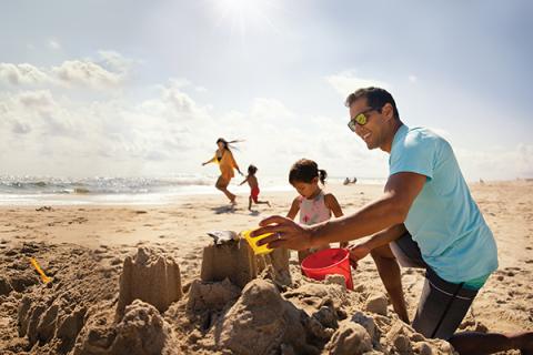 Family playing in the sand 