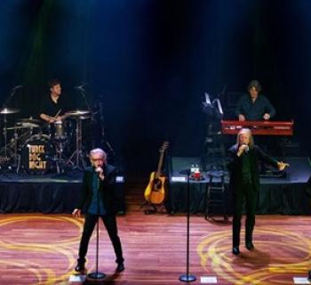 Three Dog Night playing live on a stage Photo