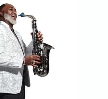Art Sherrod Jr holding saxophone smiling Photo