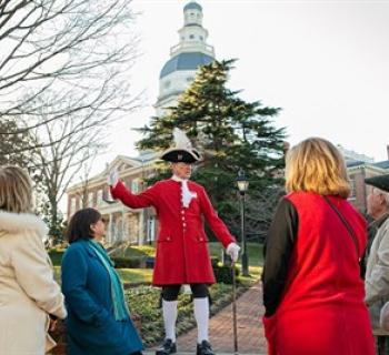 Watermark tour guide with group at the Maryland State House. Photo