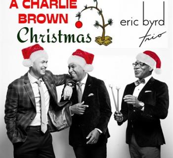 The Eric Byrd Trio laughing while wearing Santa hats Photo