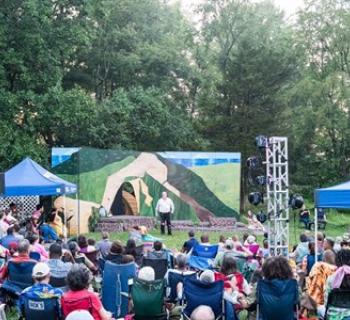 An outdoor crowd watching a performance Photo