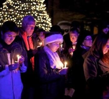 A group of attendees participating in the candle-lighting ceremony. Photo