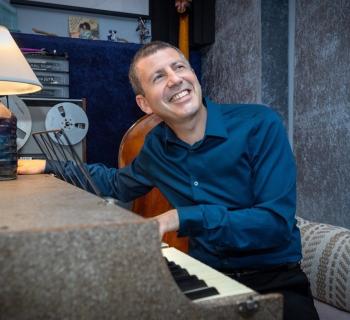 man sitting at piano Photo