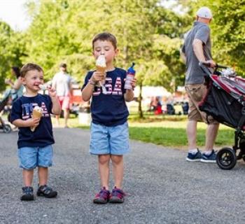 Happy kids eating ice cream at Fourth of July Celebration Photo