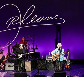 Orleans performing on a stage Photo