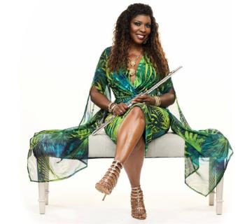 Althea Rene sitting on a bench holding a flute Photo