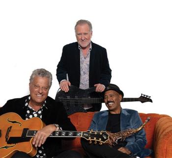 Brian Bromberg, Paul Brown, Michael Paulo sitting on couch Photo