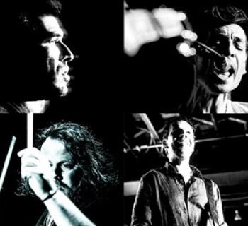 four people playing instruments Photo