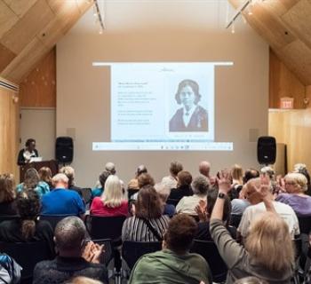 A crowd listens to a lecture Photo