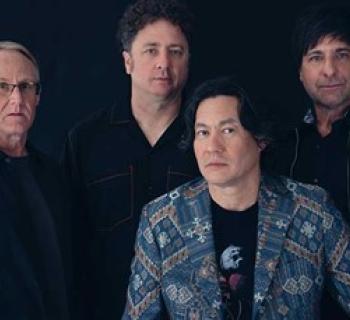 Members of Big Head Todd and The Monsters on a black background. Photo