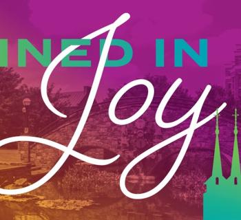 Purple background with the words Joined in Joy concert  Photo