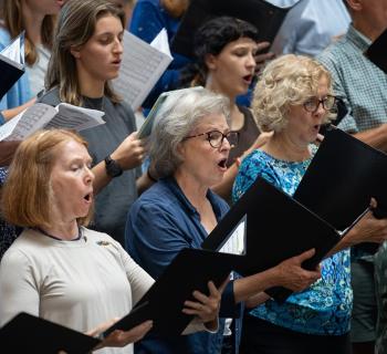 Community chorus members singing Photo