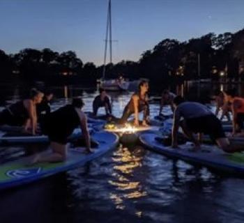 Yoga on paddleboards under the moonlight Photo