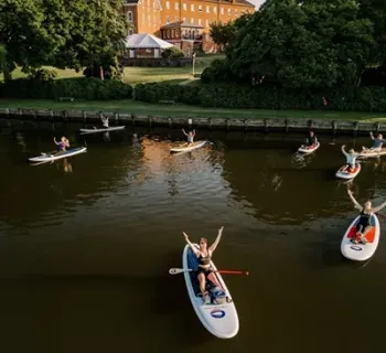 Group of people doing paddleboard yoga Photo