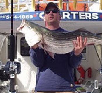 Kenneth Jeffries holding large fish aboard Charter Boat Photo