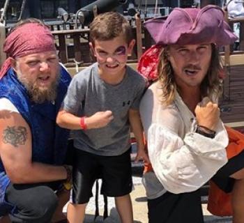 Two pirates and a young man aboard the Urban Pirates Ship Photo