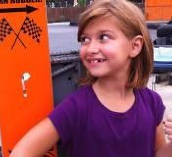 Girl giving thumbs up to racing at The Go-Kart Track-White Marsh Photo