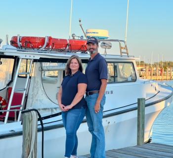 Capt. Everett & Carole Ann Landon at the dock by their boat the Circuit Rider. Photo