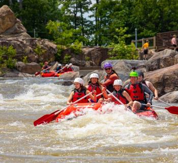 Large group whitewater rafting at Wisp Resort Photo