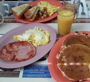 Pancakes, eggs, ham and juice Photo