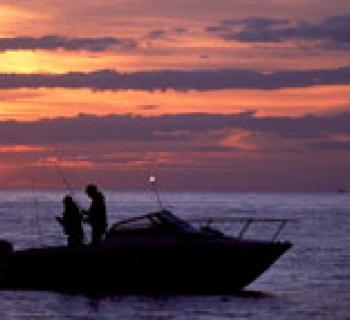 Boat on the water at sunset Photo