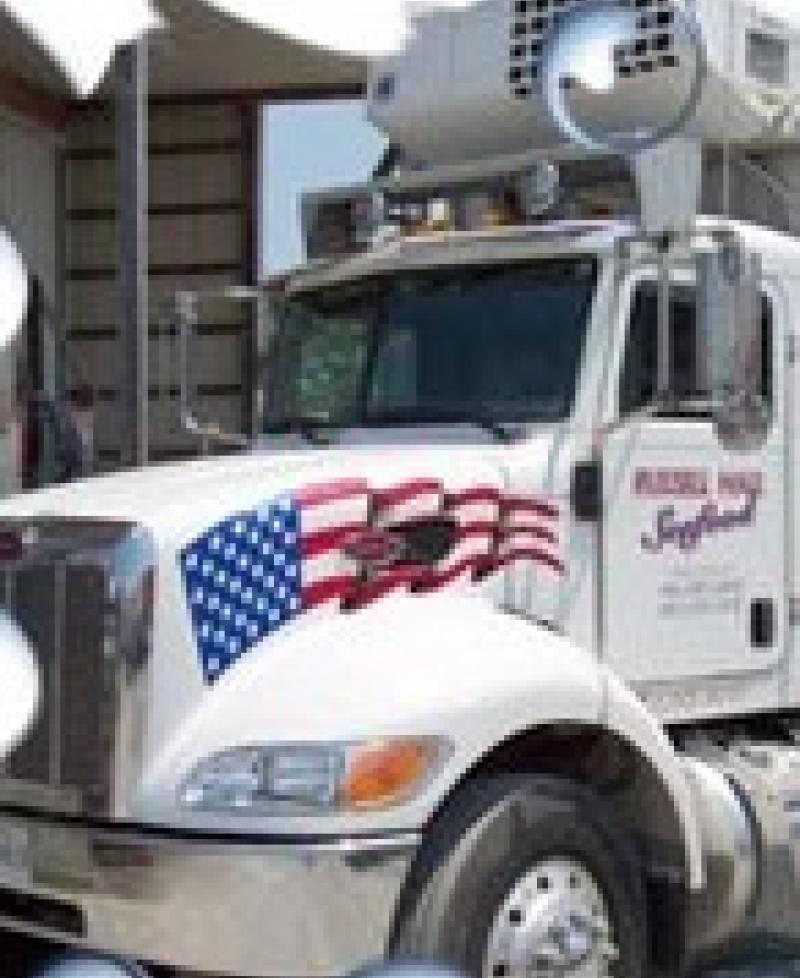 A refrigerated truck gets ready to deliver fresh seafood. Photo