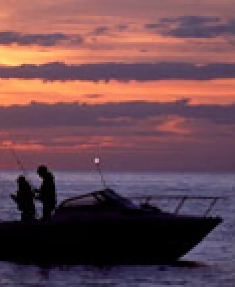 Boat on the water at sunset Photo