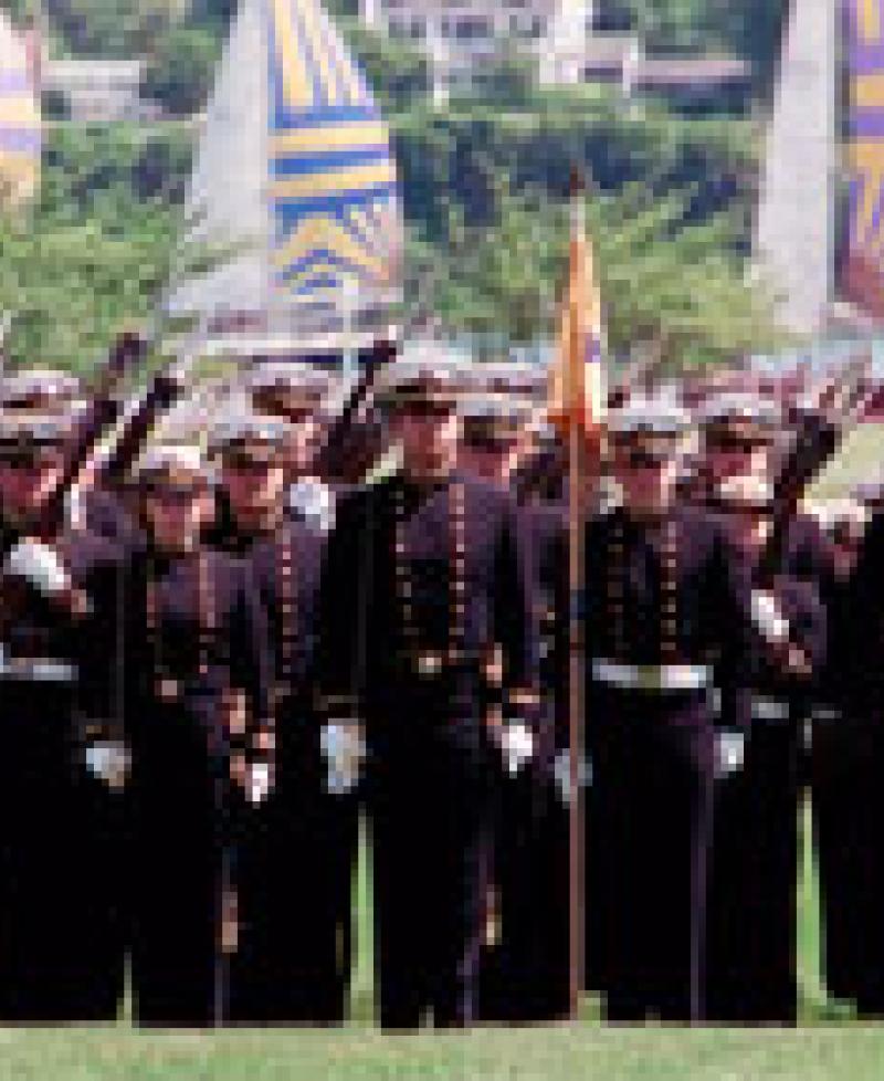 Midshipmen standing by water Photo