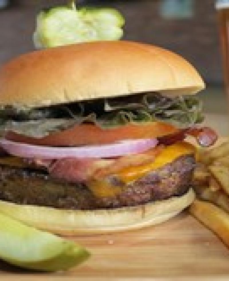 Loaded burger, fries and a pickle Photo