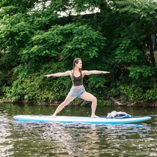 Person doing yoga on a paddleboard Photo