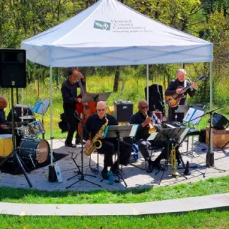 A jazz quintet performs in a garden amphitheater Photo