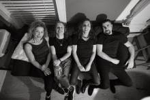 The Machine band sitting on couch Photo