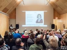 A speaker addresses an audience  Photo