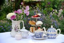 Tea and pastries set up on outdoor table. Photo