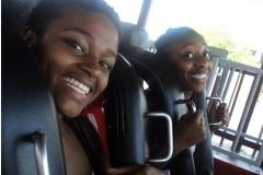 Two people riding a Roller Coaster