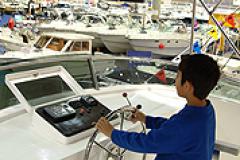 Young man steering a boat