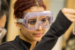 Female scientist observing a vial
