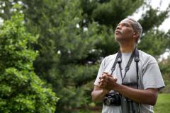man with binoculars and camera
