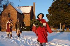 woman walking through snow in red cape