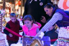 Family looking at gingerbread houses