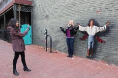 Frederick Visitor Taking Photo Next to Wall Mural Frederick Visitor Taking Photo Next to Wall Mural