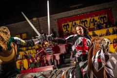 Two knights dueling with sords on horse back at Medieval Times